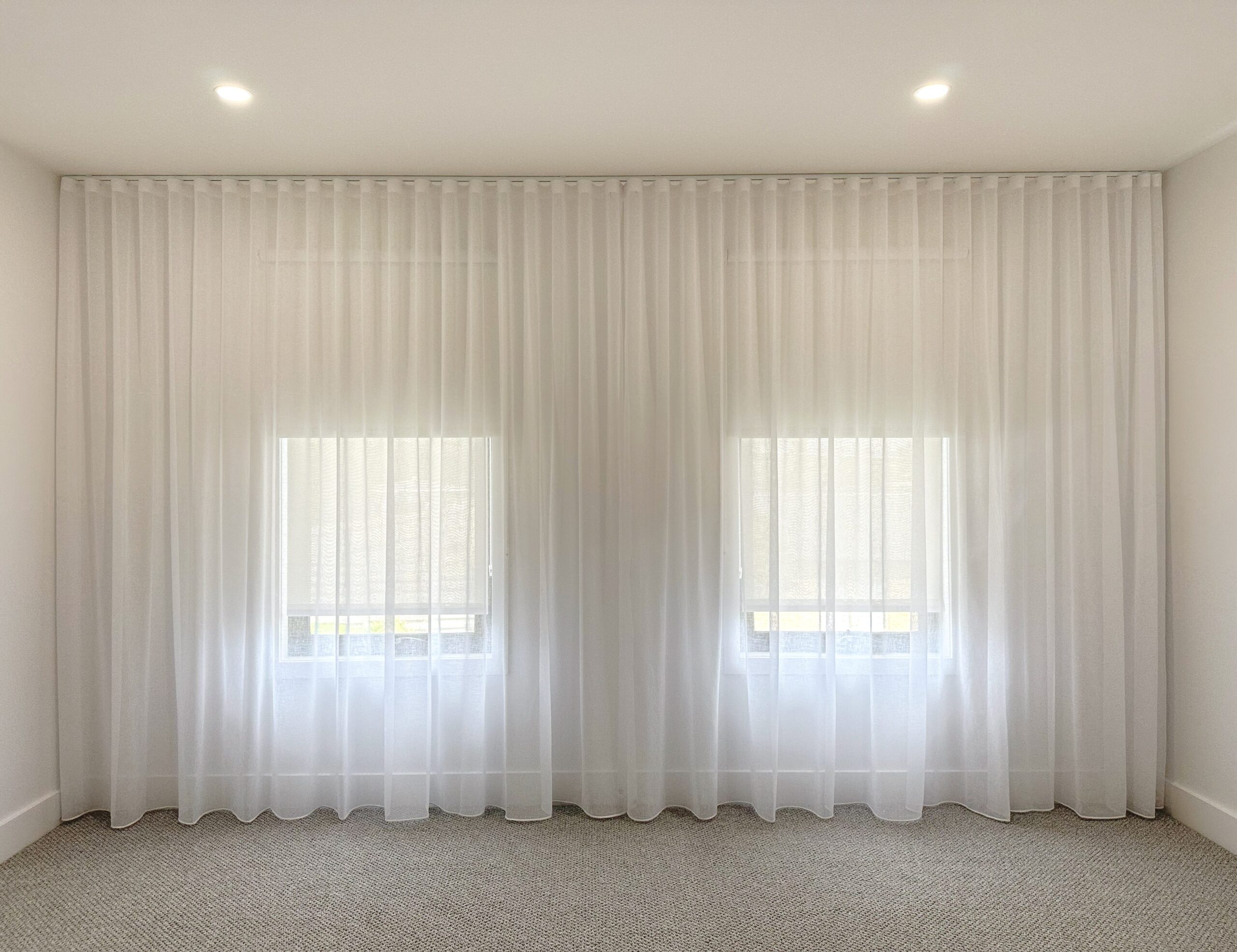 Sheer Curtains combined with blockout blinds with Centre Opening for a Master Bedroom in a newly built house in Chirnside Park.